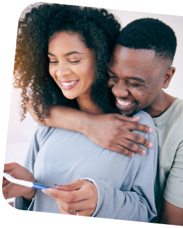Image of couple smiling at pregnancy test